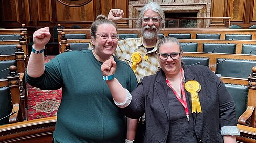 Rachel Sutherland, Alun Griffiths and Aislin Naylor celebrate in Town Hall chamber